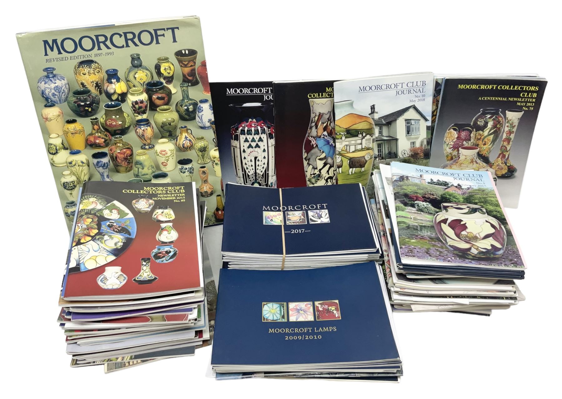 Moorcroft, 1897-1993 revised edition; an illustrated guide to Moorcroft Pottery, a hard back book by Paul Atterbury, together with a quantity of Moorcroft Collector's Club magazines
