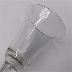 Three 18th century wine glasses comprising a plain stemmed glass with bell shaped bowl and conical folded foot H16cm, another plain stemmed glass with ogee bowl and folded foot and a Continental glass with gilt faceted bowl, decorated with male figure within a landscape, on a clear Silesian seven sided cut stem (3)