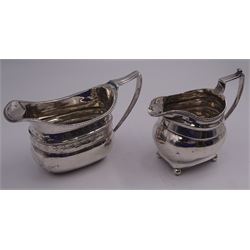 George III silver cream jug, of oblong form with stipple engraved foliate bands, gadrooned rim and flat topped curved handle, hallmarked London 1808, makers mark worn and indistinct, including handle H9cm, together with another similar smaller Georgian example, of slightly bellied form, upon four ball feet, hallmarks worn and indistinct, probably George III, including handle H10cm, approximate total weight 8.52 ozt (265.3 grams)