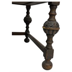 Early 20th century Jacobean design oak desk, with rectangular top inset with worn tooled leather, two frieze drawers over pedestals each fitted with a pair of panelled drawers, turned handles, on carved and fluted tapering legs united by stretchers 