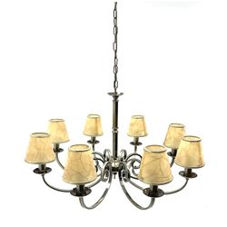 A large brushed effect eight branch chandelier, the scrolling branches supporting parchment type shades with gilt veining, chandelier approximately H47cm L78cm. 