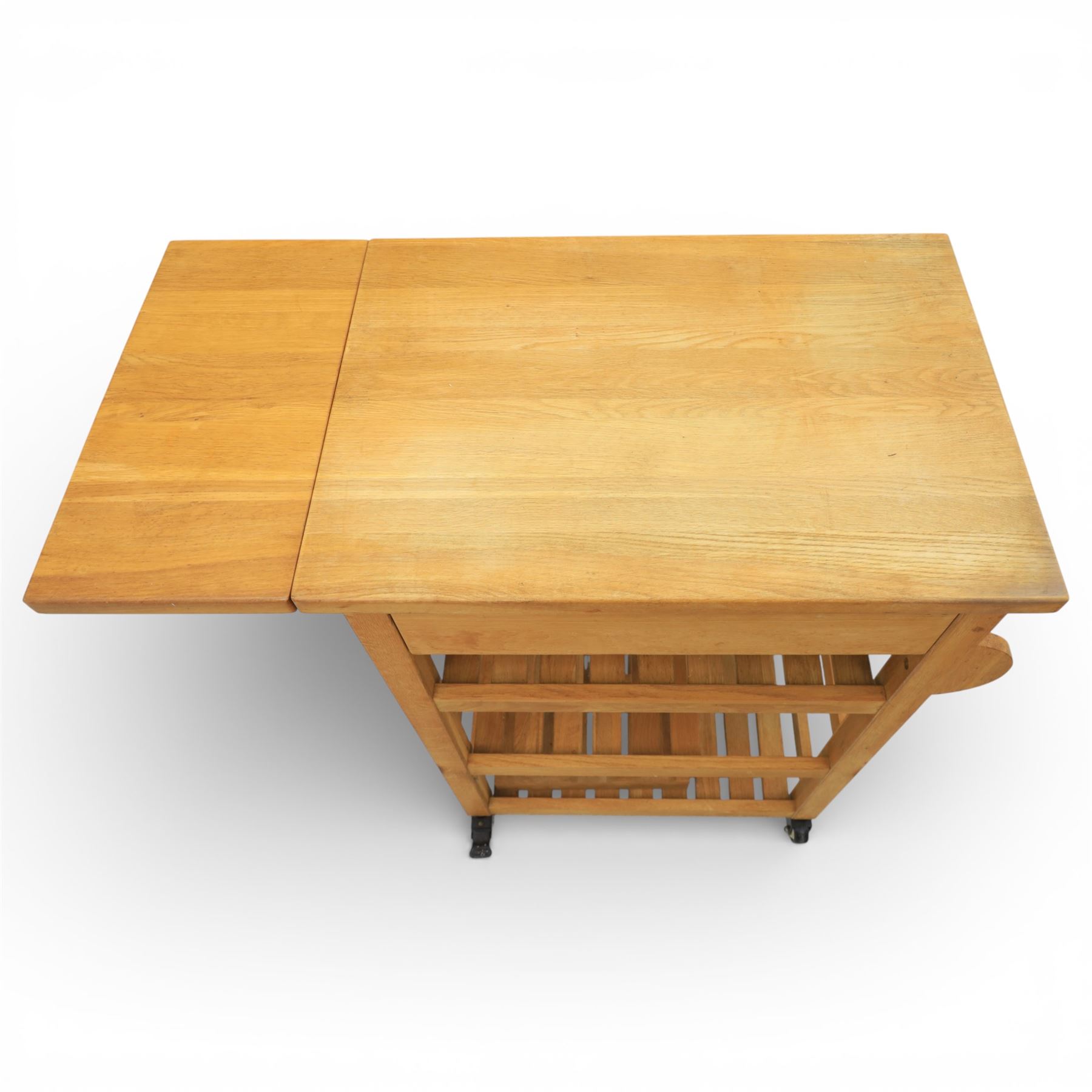 Modern oak butchers block, drop leaf end with towel rail to the other side, above three tiers raised on plastic castors 