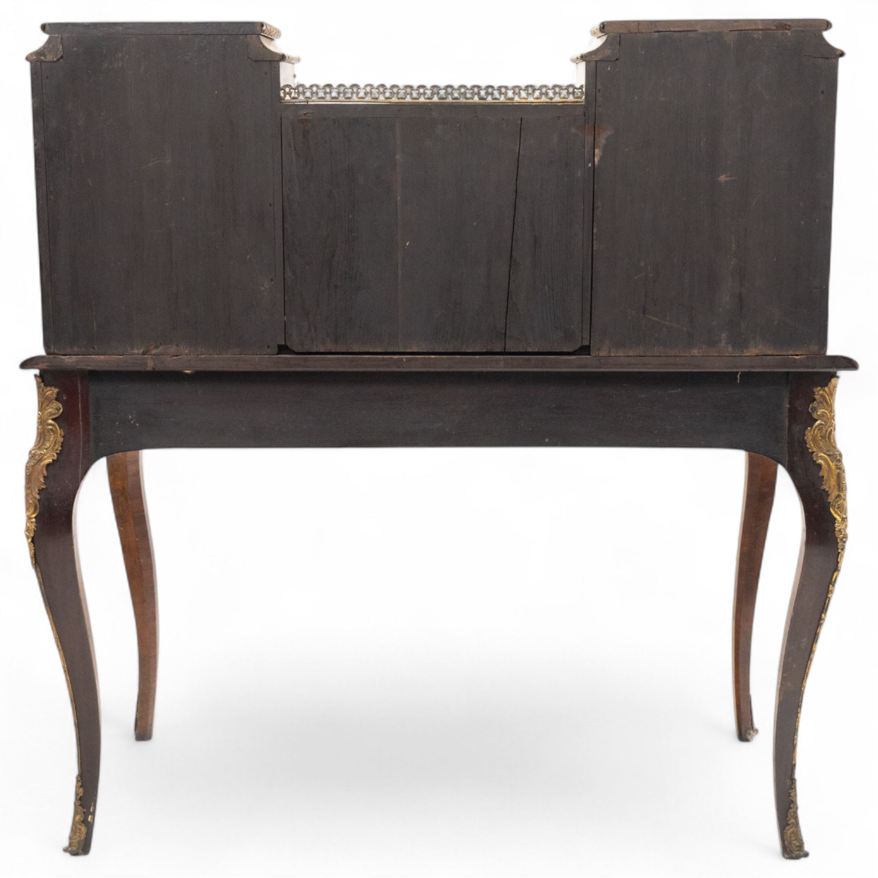 Late 19th-century Louis XV revival gilt bronze mounted and walnut Bonheur-de-Jour, rectangular-shaped serpentine form, with gilt bronze beading, frieze with two blind drawers and gilt bronze handles, centre drawer with large central serves style porcelain plaque, the elevated section with brass gallery above panelled cupboard doors also with serves style porcelain plaques and gilt bronze mounts, interior with single shelf, central section with four drawers each with gilt bronze handles, raised on slender cabriole legs fitted with gilt bronze rococo style masks and sabots