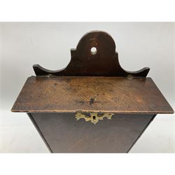 Two oak George III hanging candle boxes, the first example being of tapering rectangular form with brass escutcheon and the further being of octagonal form with studded leather hinges, tallest H43ccm