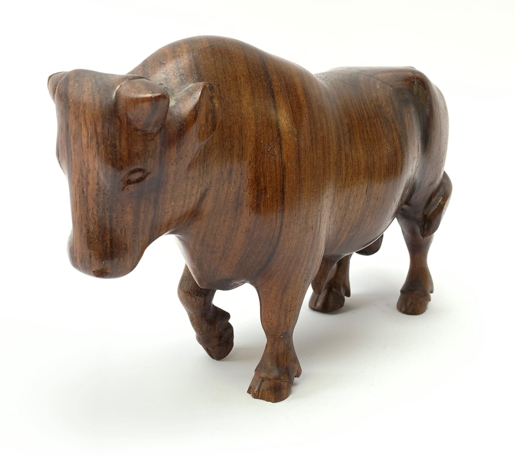 Ann Baxter (British b. 1969): a carved wooden model of a Bull, signed beneath A.W. Baxter, L22cm x H14cm 