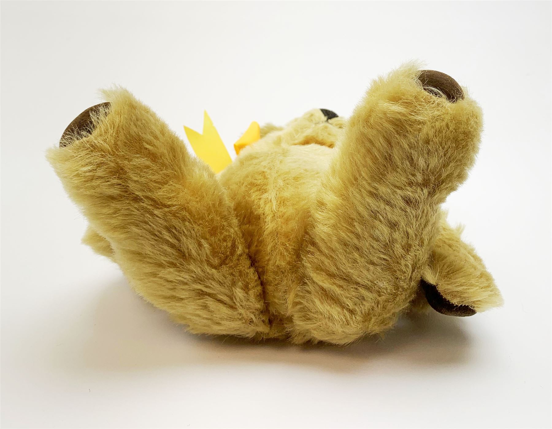 Chad Valley Hygienic Toys teddy bear c1950, kapok filled mohair plush body with original factory given yellow neck ribbon, jointed limbs with velvet paw pads, glass eyes and vertically stitched nose and mouth, blue/white printed label to side seam H12