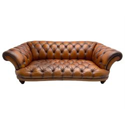 Tetrad - 'Oskar' grande three-seat sofa, Chesterfield shape with rolled arms, upholstered in buttoned tan leather, on turned and reed moulded feet 