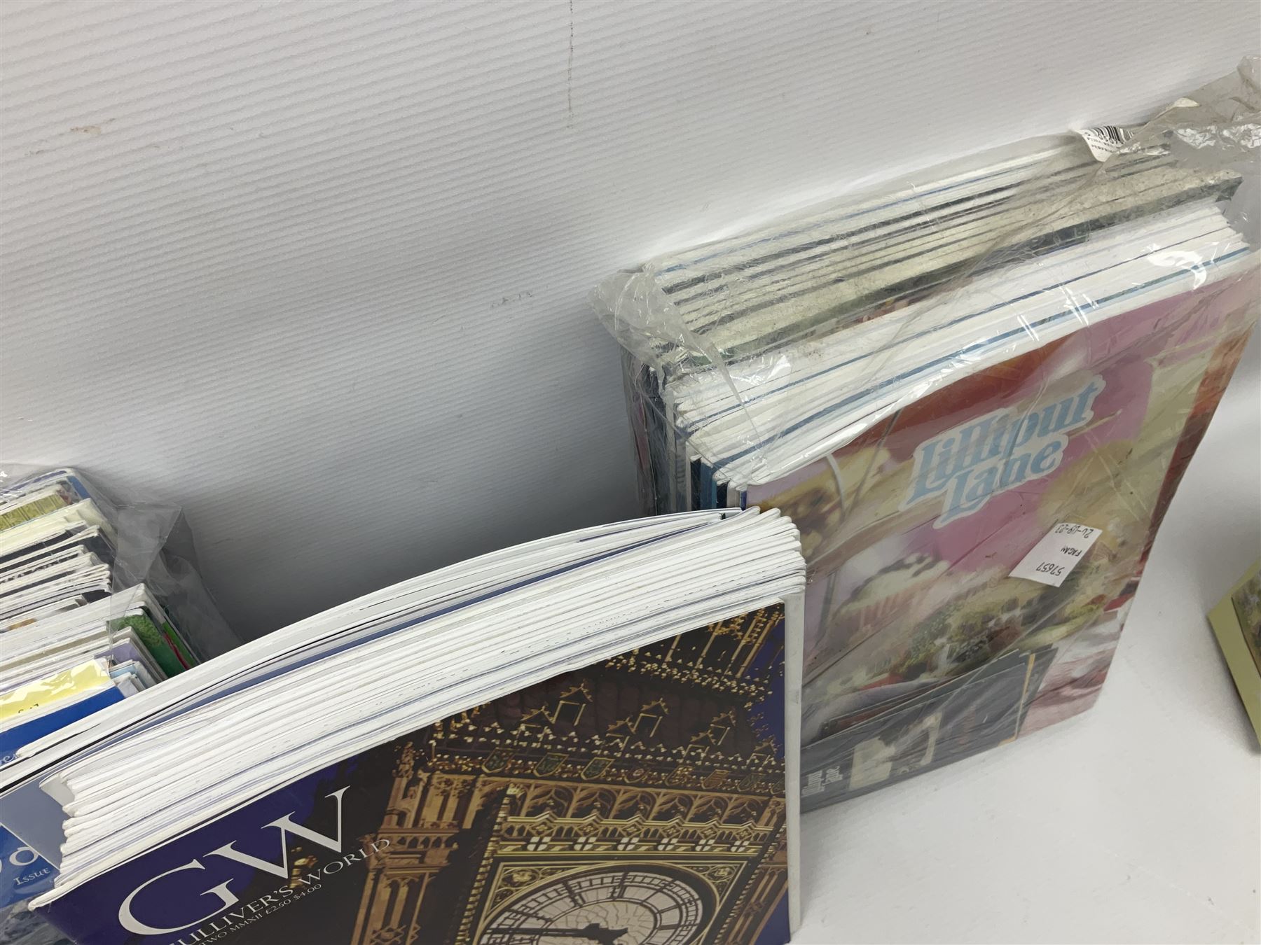 Twenty three Lilliput Lanes, including Village School, Lace's Shoe Shop, Cockles & Muscles, Scotland the Brave etc, together with The Leonardo Collection Paint Box Poppets and Gullivers World magazines 