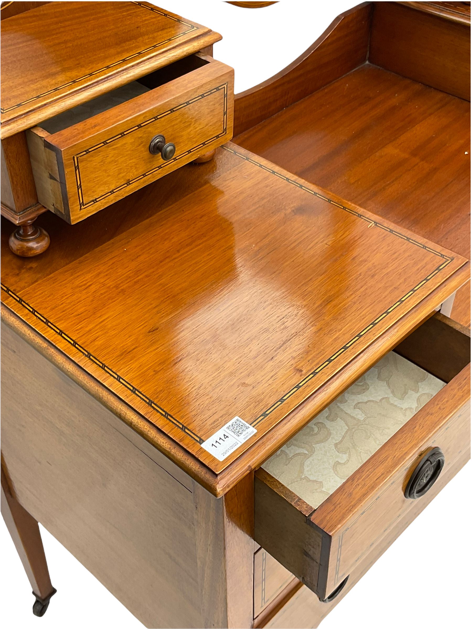 Edwardian inlaid mahogany dressing table, oval swing mirror, trinket drawers, above two small and two long drawers