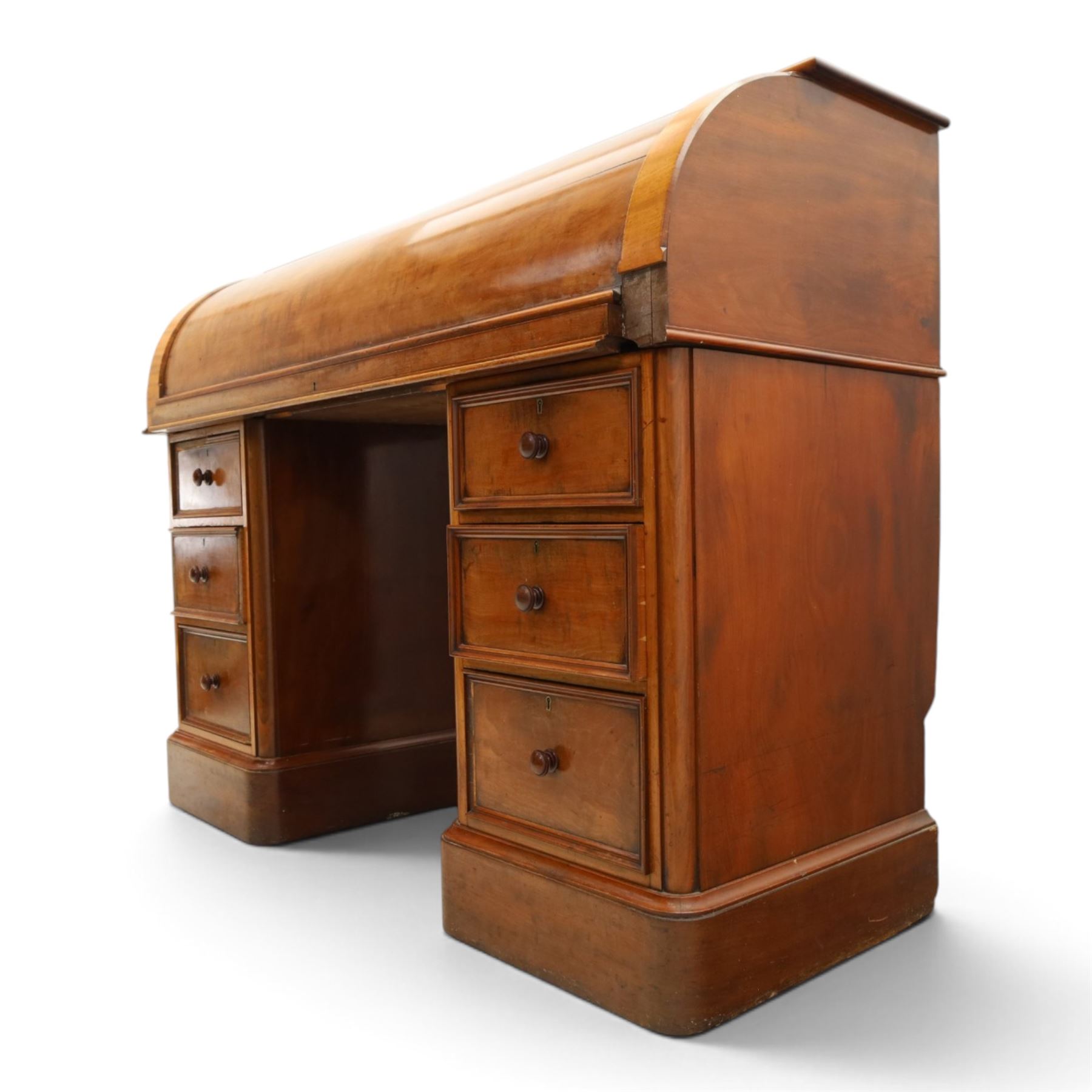 Victorian mahogany twin pedestal cylinder desk, with roll top with fitted interior and with leather writing slide, raised on pedestals with three graduating drawers, raised on a plinth base with castors