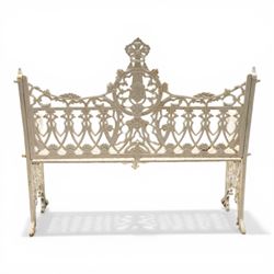 Victorian revival heavy cast iron garden bench, ornate back rest with scrolls, floral motifs and central crest, pierced lattice seat, curved arms and decorative legs, painted in antique white, in the Gothic Coalbrookdale style