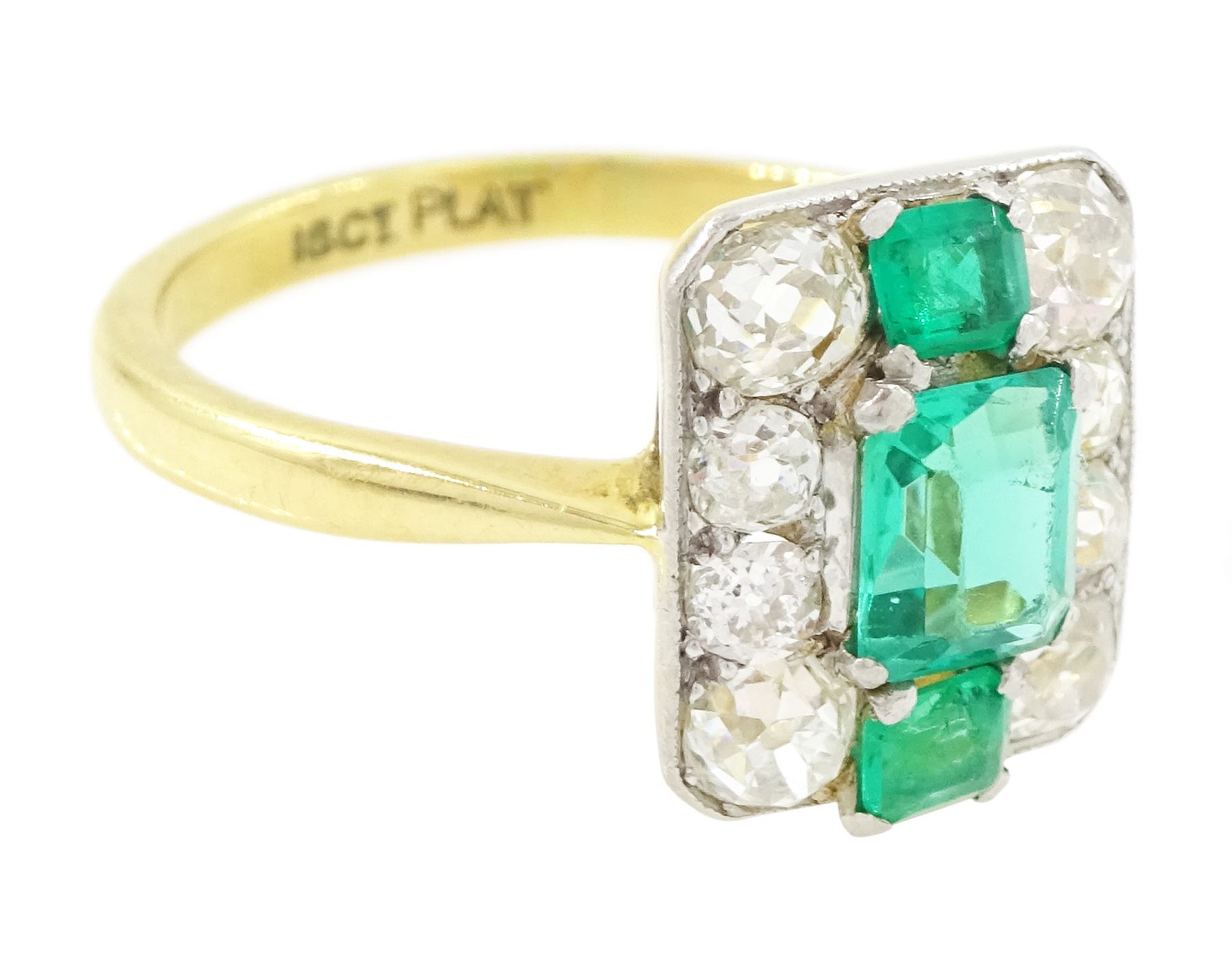 Early 20th century gold emerald and diamond panel ring, three octagonal cut emeralds, with four old cut diamonds set either side, stamped 18ct Plat, total diamond weight approx 0.85 carat