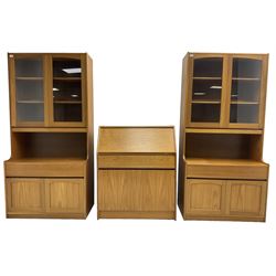 Sutcliffe of Todmorden - pair of teak wall units, fitted with two glazed doors over drawer and double cupboard (W86cm, D45cm, H198cm); and a matching fall front bureau (W84cm, D41cm, H100cm)