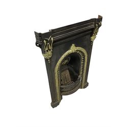 Cast iron fire place, ornate moulded arch and corbels, black and gilt finish