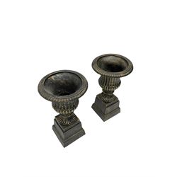 Pair Victorian design cast iron Campana shaped garden urns with base, in black and gilt finish 