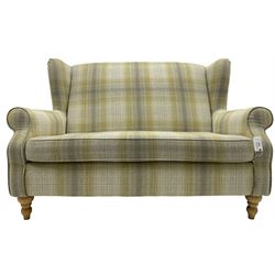 Next Home - two-seat hardwood framed wingback sofa, upholstered in pale green checkered fabric, on turned front feet