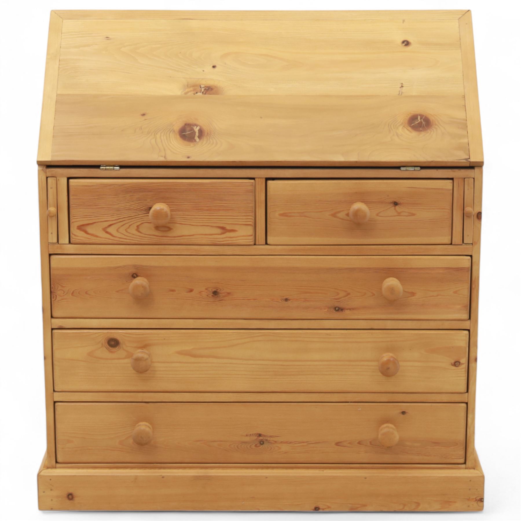 Contemporary waxed pine bureau, fall front enclosing fitted interior with pigeonholes and drawers, over two short and three long drawers with turned wooden knobs, on plinth base