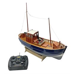 Model two masted fishing boat, on wooden stand, with a HiTec Ranger II N remote control, untested