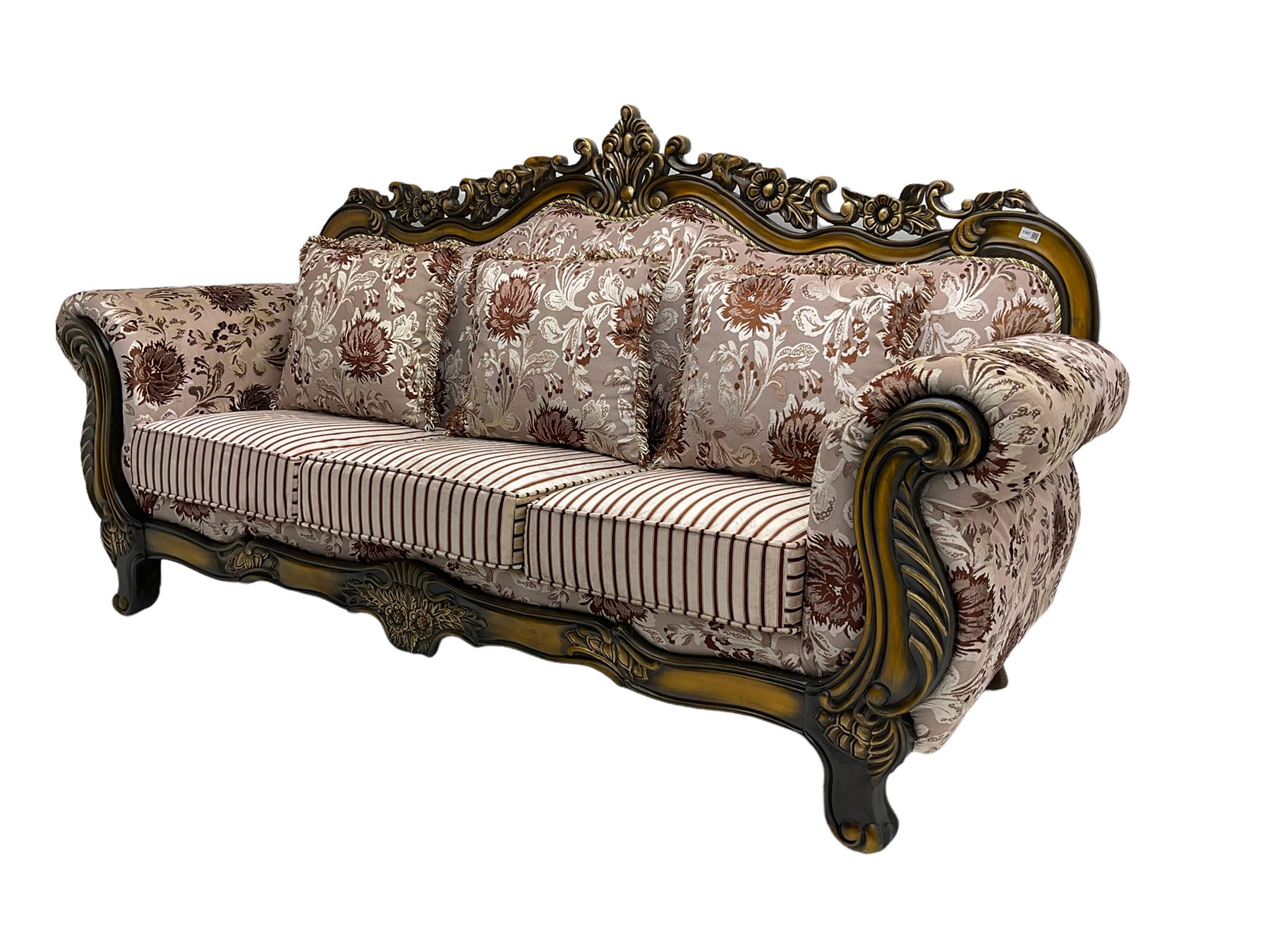 Italian Baroque design three seat sofa, hardwood framed, the cresting rail carved and pierced with c-scrolls and flower heads, scrolled arms, upholstered in floral patterned and striped fabric, with scatter cushions 
