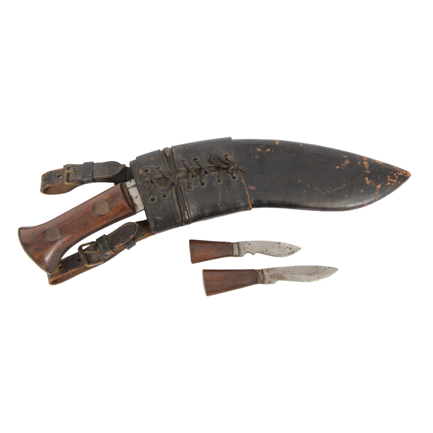 Two WWII Kukri knives, wooden grip with brass cap to pommel, single edged curved blade, within leather scabbard with belt attachments, overall L40cm 