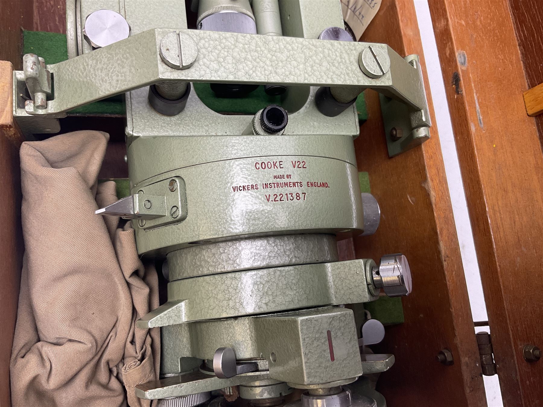 Vickers Instruments England Cooke V22 surveyor's theodolite, No.V.221387, with green enamelled body H32cm; in fitted wooden carrying box with retaining bar and repair label dated 3/8/77.
