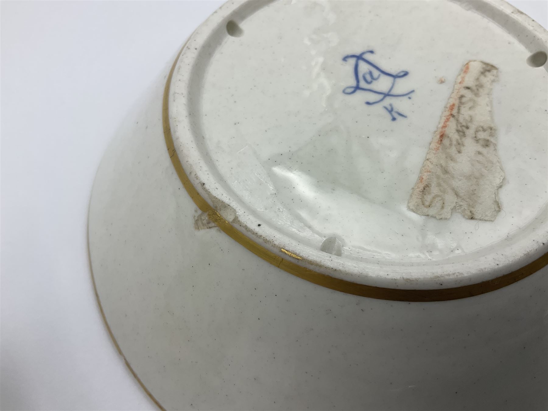 Sèvres soft paste porcelain coffee can and saucer with date code for 1754, painted and gilded with flowers, dangling from the shaped green border, interlaced LL monogram enclosing the date letter A above painters mark for Dodin, coffee can H7cm, saucer D14.5cm