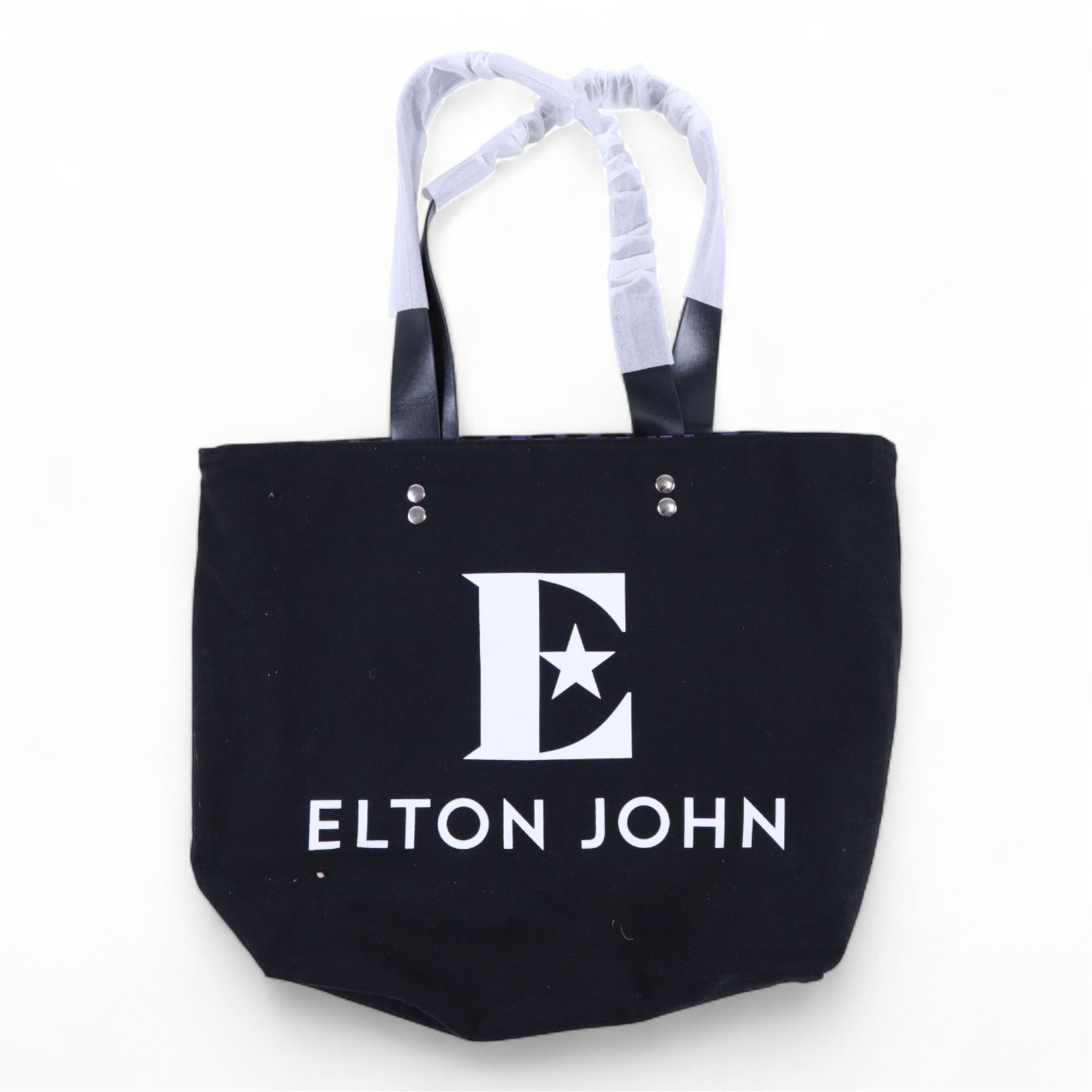 Elton John Farewell Yellow Brick Road tour merchandise, comprising programme, tote bag and VIP giftset with lanyard, wallet, luggage tag and keyring, in white box with gilt lettering, together with two limited edition Farewell Yellow Brick Road lithographs