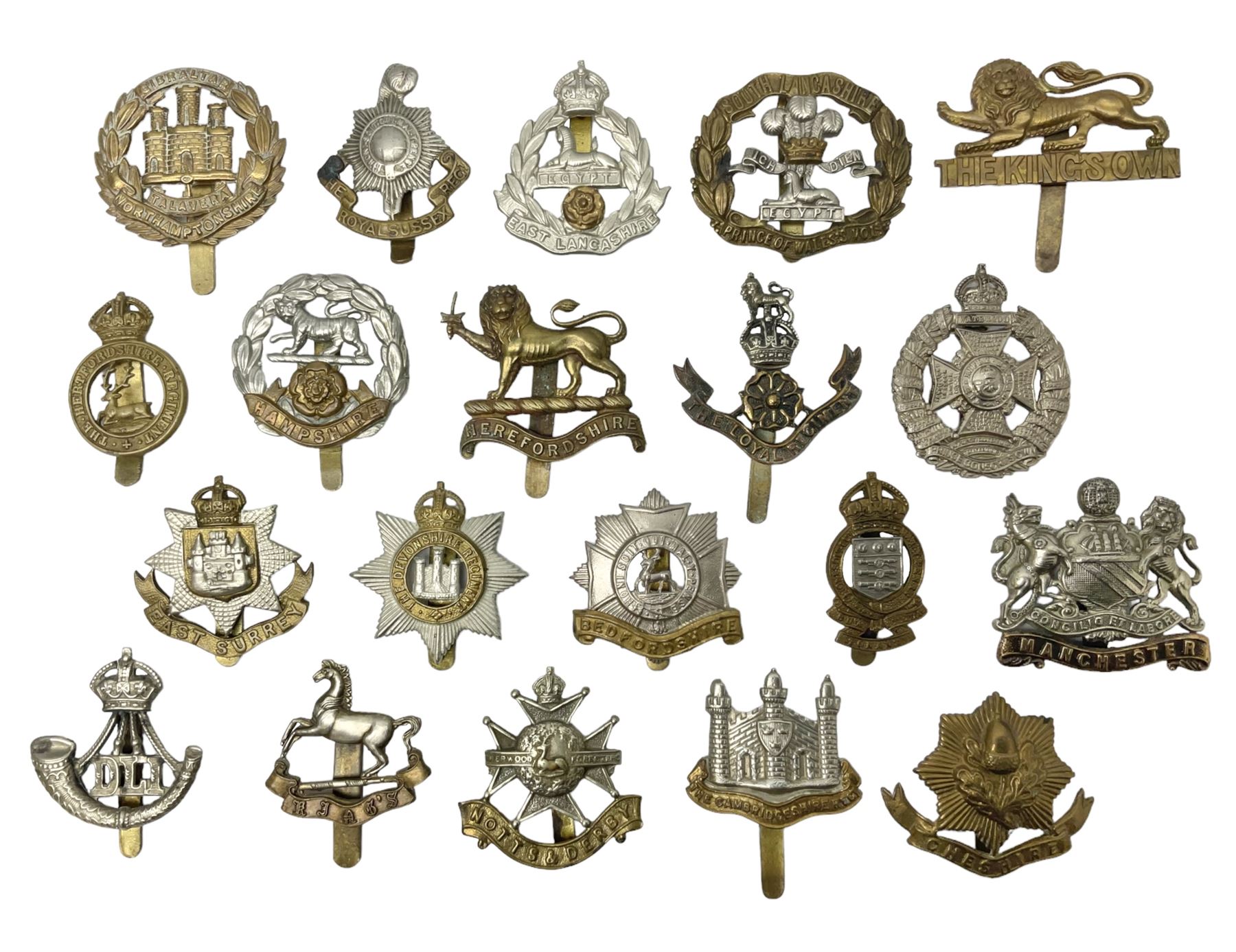 Twenty cap badges including Hertfordshire, Royal Sussex, Cambridgeshire, Hampshire, Notts and Derby, East Surrey, Herefordshire, South Lancashire, Devonshire, Bedfordshire, Durham Light Infantry etc (20)