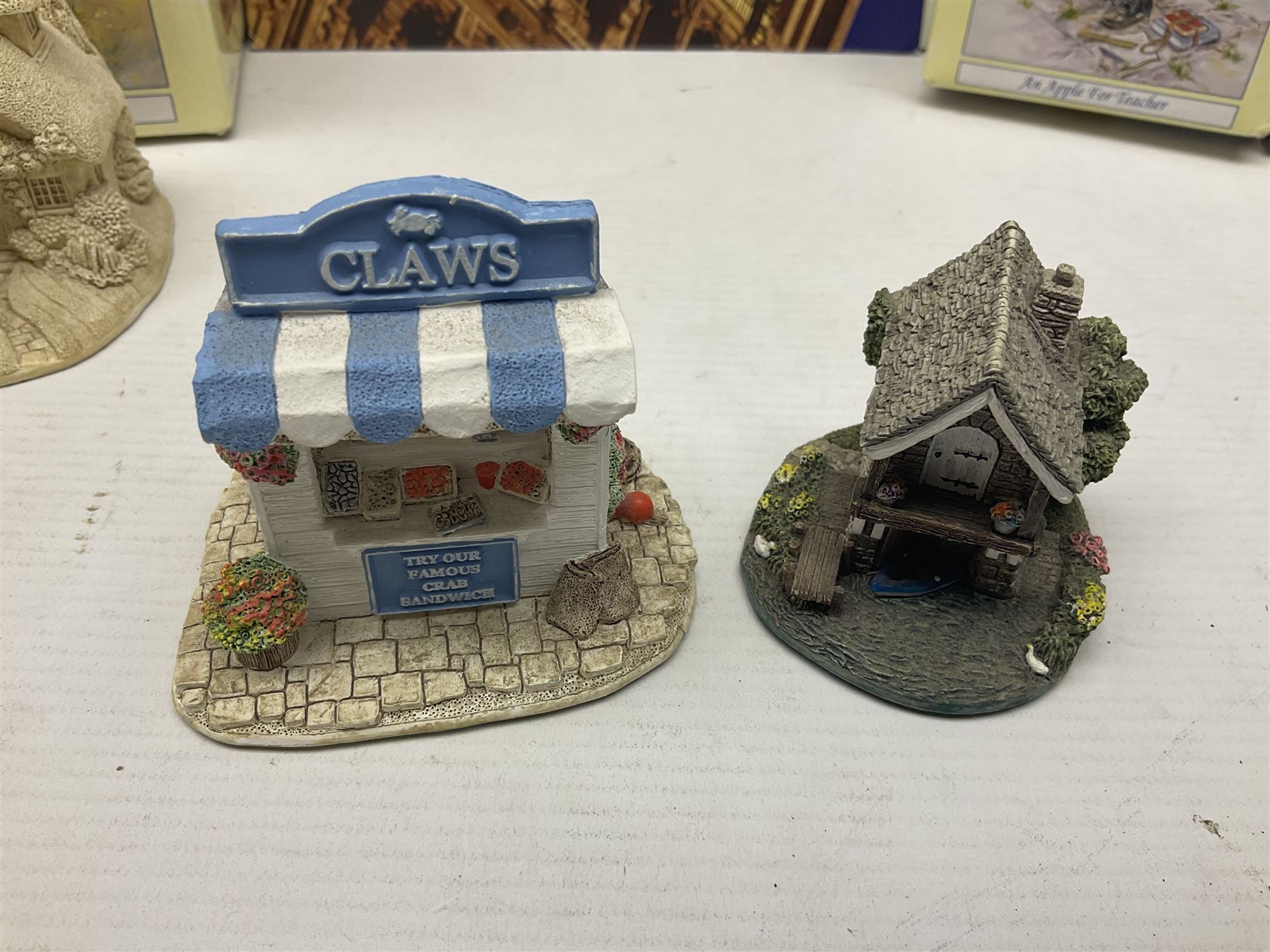 Twenty three Lilliput Lanes, including Village School, Lace's Shoe Shop, Cockles & Muscles, Scotland the Brave etc, together with The Leonardo Collection Paint Box Poppets and Gullivers World magazines 