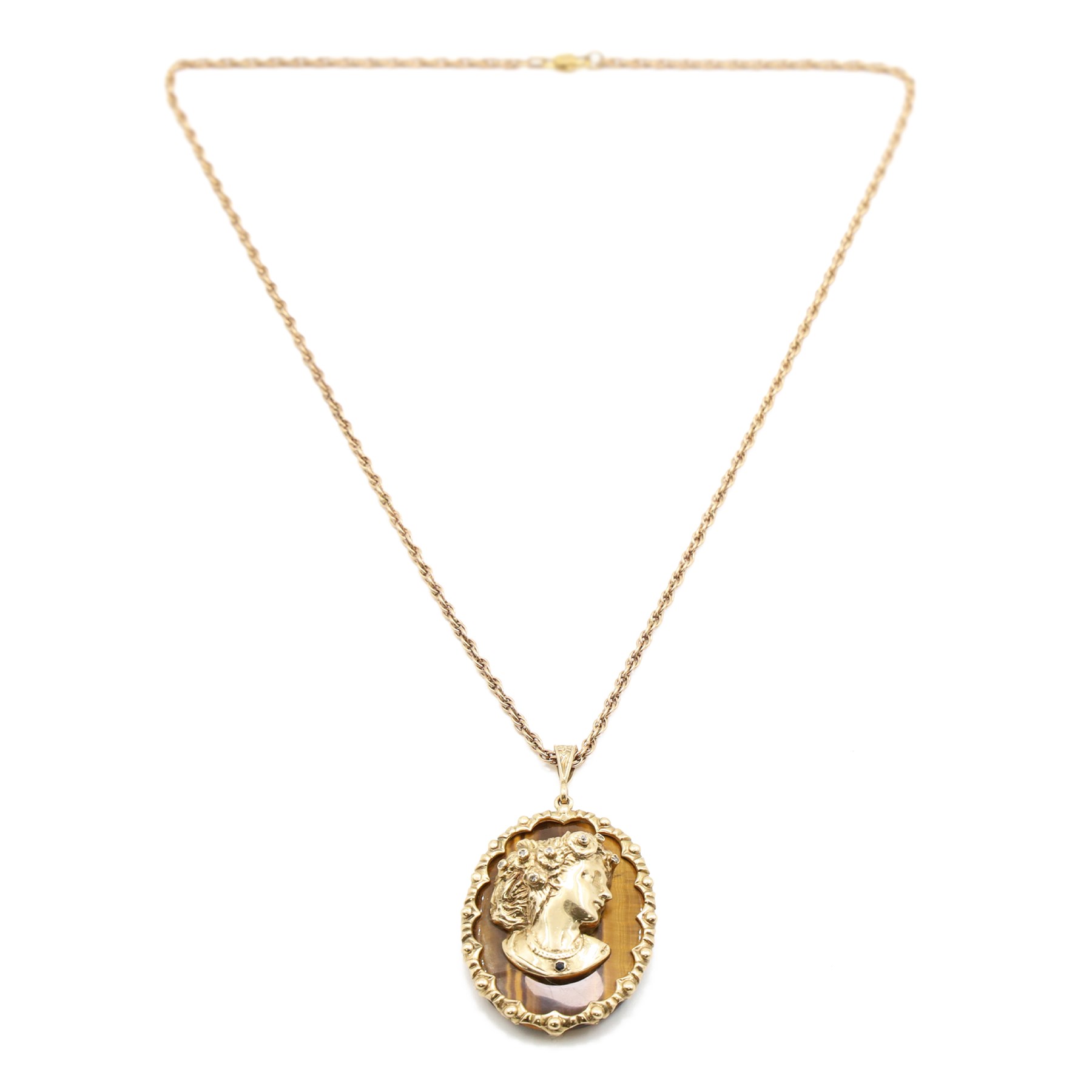 9ct gold tiger's eye diamond and sapphire portrait pendant necklace, oval cut tiger's eye, with applied bust of a lady in profile, her hair set with diamonds and necklace set with a sapphire, within a scalloped design frame, on a fancy twist chain necklace, both hallmarked
