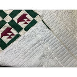 20th century quilt, with repetitive ship design to the centre within a cream red and green boarder, 227cm x 222cm