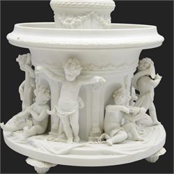 Volkstedt bisque centrepiece, with flower encrusted urn upon a circular reservoir detailed with applied putti playing instruments, marked, H40cm
 
