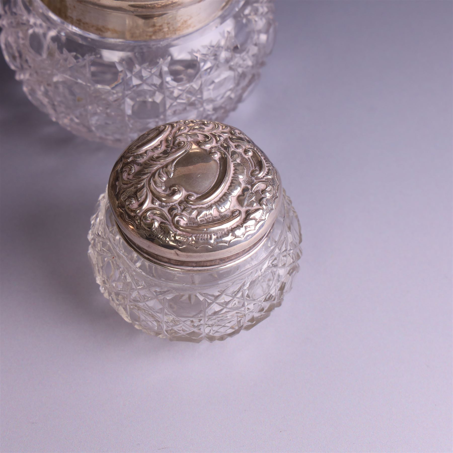 Early 20th century silver mounted cut glass scent bottle, with silver lid and three cut glass dressing table jars with silver lids, all hallmarked 