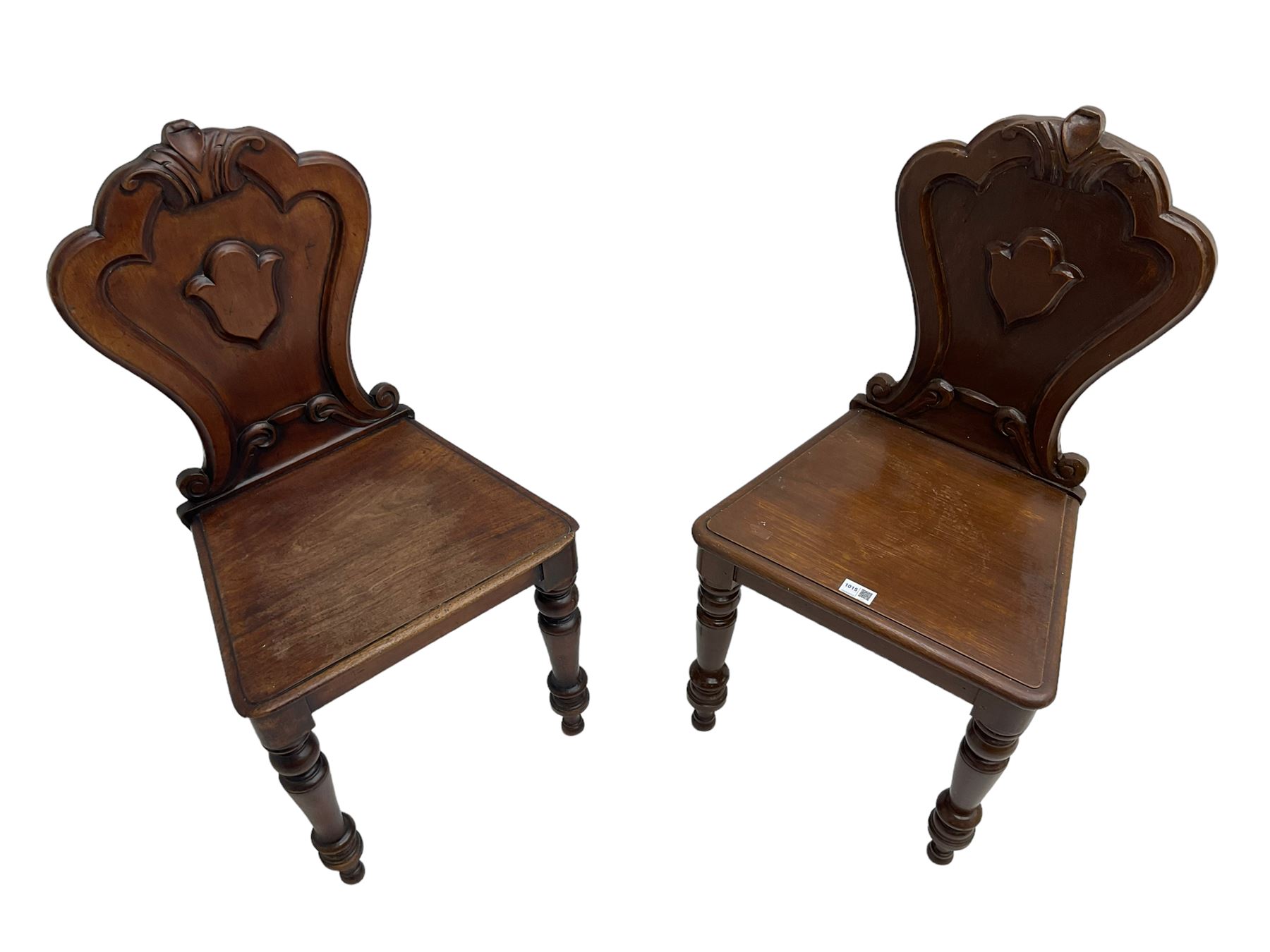 Pair of Victorian mahogany hall chairs, shaped moulded back carved with cartouche, moulded seat on turned front supports