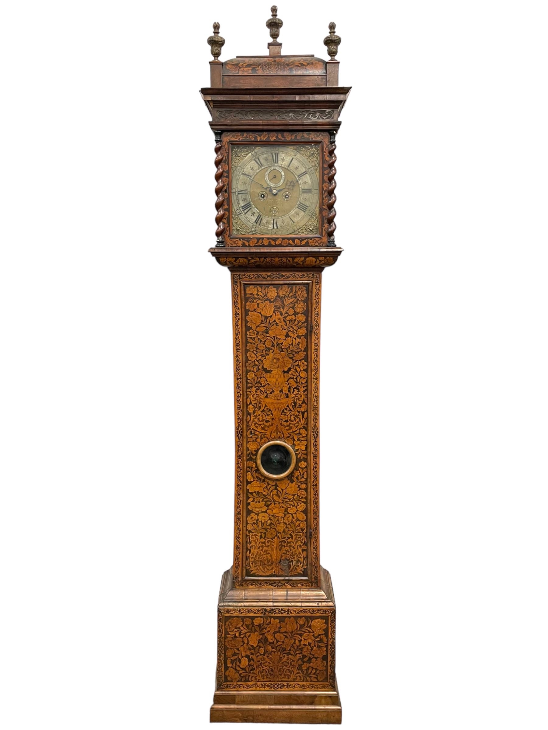 William & Mary floral marquetry 8-day longcase clock c 1700, later mid-18th century four pillar rack striking movement with a square brass dial and subsidiary seconds dial, ringed winding holes and calendar aperture to the matted dial centre, with London cherub head cast spandrels and (later) fretted steel hands, silvered Roman numeral chapter ring with stylised fleur di Lis half hour makers, narrow Arabic five-minutes, minute track and inner quarter hour track, signed Thomas Horlock, Hammersmith, 
case with box upstand to the domed floral marquetry decorated caddy with three brass flame finials, above a moulded cornice and fretwork frieze,  inlaid hood door with attached barley twist pillars to the front above an inlaid convex moulding, full length D moulded trunk door with a circular lenticle inlaid with floral and foliage panels inhabited with birds, on a conforming marquetry plinth with applied double skirting. Thomas Horlock is recorded as a Whitesmith & Clockmaker of Hammersmith, Middlesex.
A copy of Thomas Horlock's will dated the 15th June 1757 is held at The National  Archives Kew.