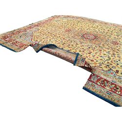 Large Amritsar camel ground carpet, central floral medallion within an interlocking foliate field, five band border, the main band decorated with repeating stylised flower head motifs