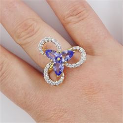 18ct gold tanzanite and diamond cluster ring, three pear cut tanzanite's, with round brilliant cut diamond surround, in an openwork swirl setting, hallmarked, total tanzanite weight 1.50 carat, total diamond weight 0.55 carat, with World Gemological Institute Report