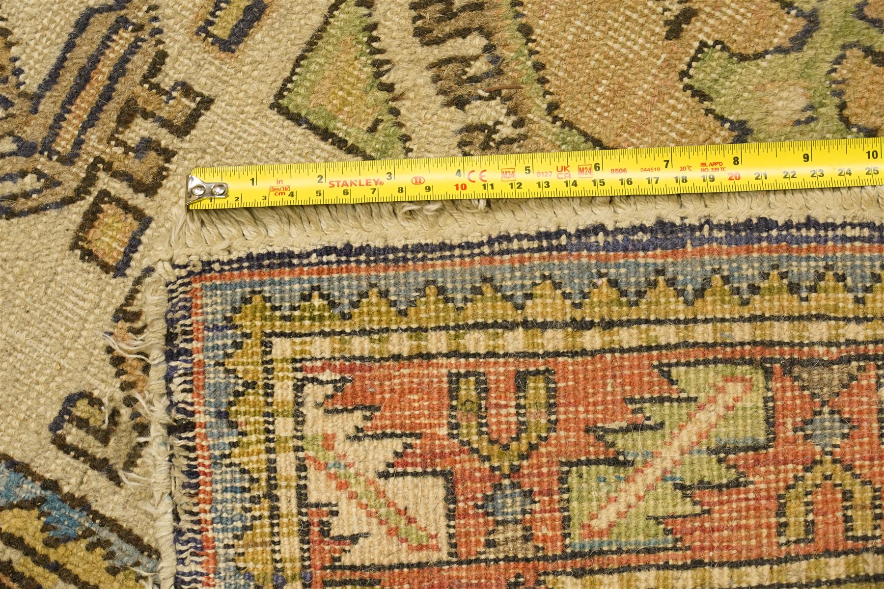 Two Caucasian designed rugs comprising a flatweave and hand-knotted rug, Caucasian design flatweave, cream ground with three large blue geometric medallions surrounded by stylised birds and geometric motifs, enclosed by repeating geometric border, fringed ends, H176cm, W102cm; hand-knotted Caucasian rug, ivory ground with three polychrome octagonal medallions surrounded by stylised animals, flowerheads and geometric motifs, enclosed by salmon pink geometric border, fringed ends, H163cm, W106cm