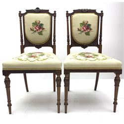 Pair of Victorian walnut salon chairs by James Winter and Sons 151-155 Wardour Street, London, stamped under, the frame with delicate floral carving, seat and back upholstered in floral needlework fabric, raised on ring turned and fluted supports 