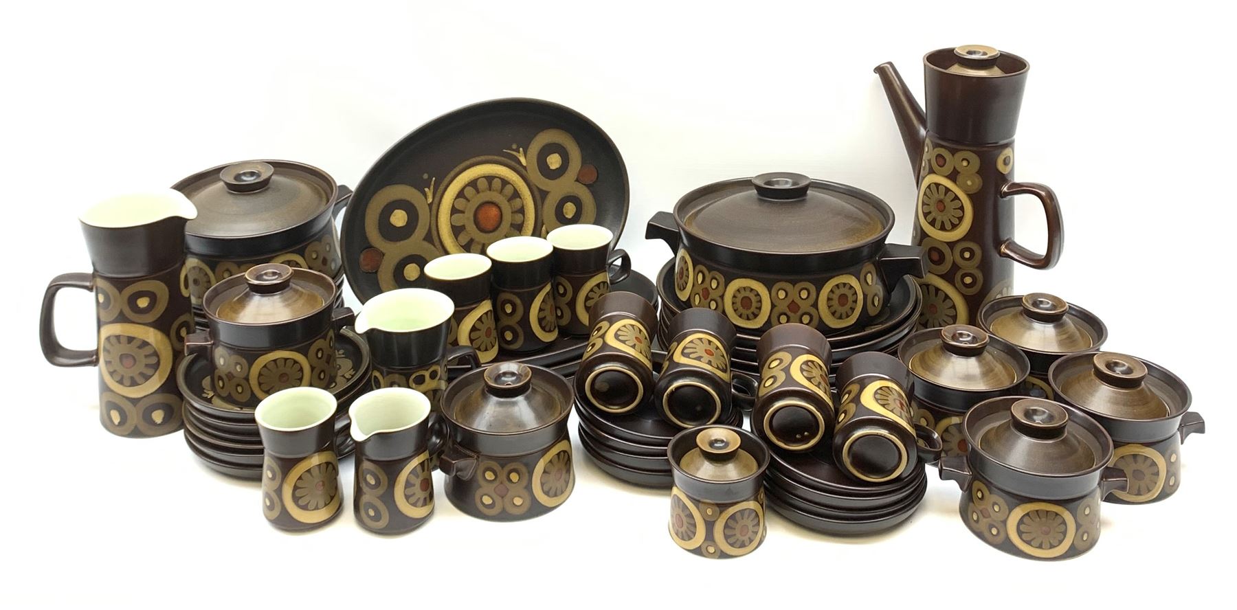 Denby Arabesque patter tea and dinner wares, comprising six dinner plates, twelve side plates, six twin handled bowls and covers, two tureen and covers, four oval serving platters, coffee pot, water jug, milk jug, cream jug, sucrier and cover, and eight coffee cans. 