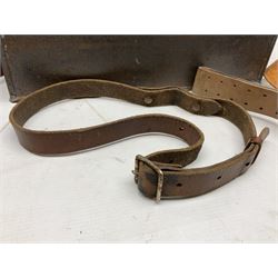 Assorted militaria including ten leather or canvas cartridge and other belts, maroon beret with 17th Lancers cap badge, modern bullet mould, leather and brass shot flask, two knives, shell cases, boomerang etc; in tin deed box