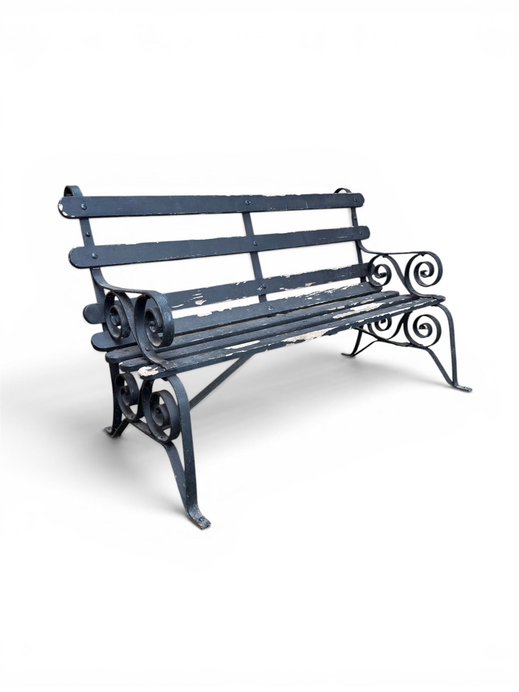 Coalbrookdale - rare pair of wrought iron and slatted wood garden benches, the twin wrought iron strapwork bench-ends formed of four scrolls over splayed feet, number 77 in the Coalbrookdale Castings Catalogue (see illustration)