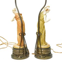 Pair of Royal Worcester table lamps modelled by James Hadley with female musicians with two branch metal fittings and filigree finials on circular bases H75cm