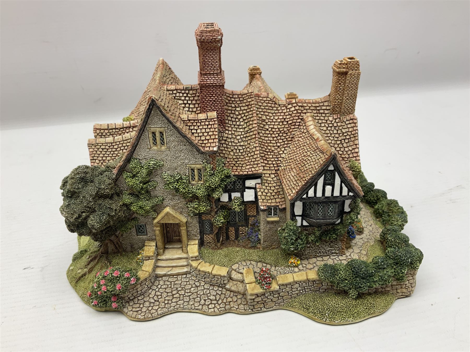 Three Lilliput lanes, comprising Oakwood Smithy, Anne of Cleves and Bluebell Farm, all with deeds and original boxes 