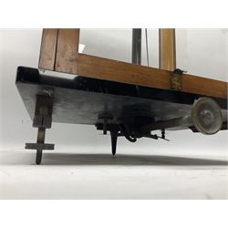 Set of laboratory balance scales by Reynolds & Branson of Leeds in fully glazed mahogany case with rise-and-fall front door, black vitrolite base with brass feet and hand cranked action L40cm H51.5cm D30cm; and bakelite cased set of brass weights