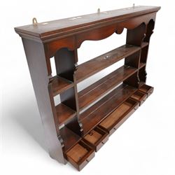 Georgian design mahogany wall rack, moulded cornice over shaped frieze and thee shelves, fitted with five drawers