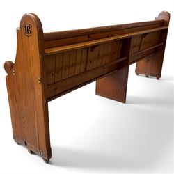 Early 20th century stained pine ecclesiastical church pew, the shaped end supports flanking slatted and panelled back, with black stencilled number '16' to the side
