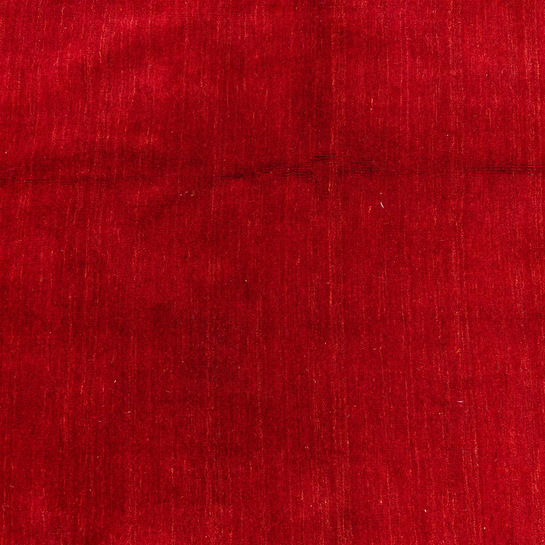 Indian hand-knotted wool Gebbeh design carpet, of rectangular form, woven in a rich madder red tone