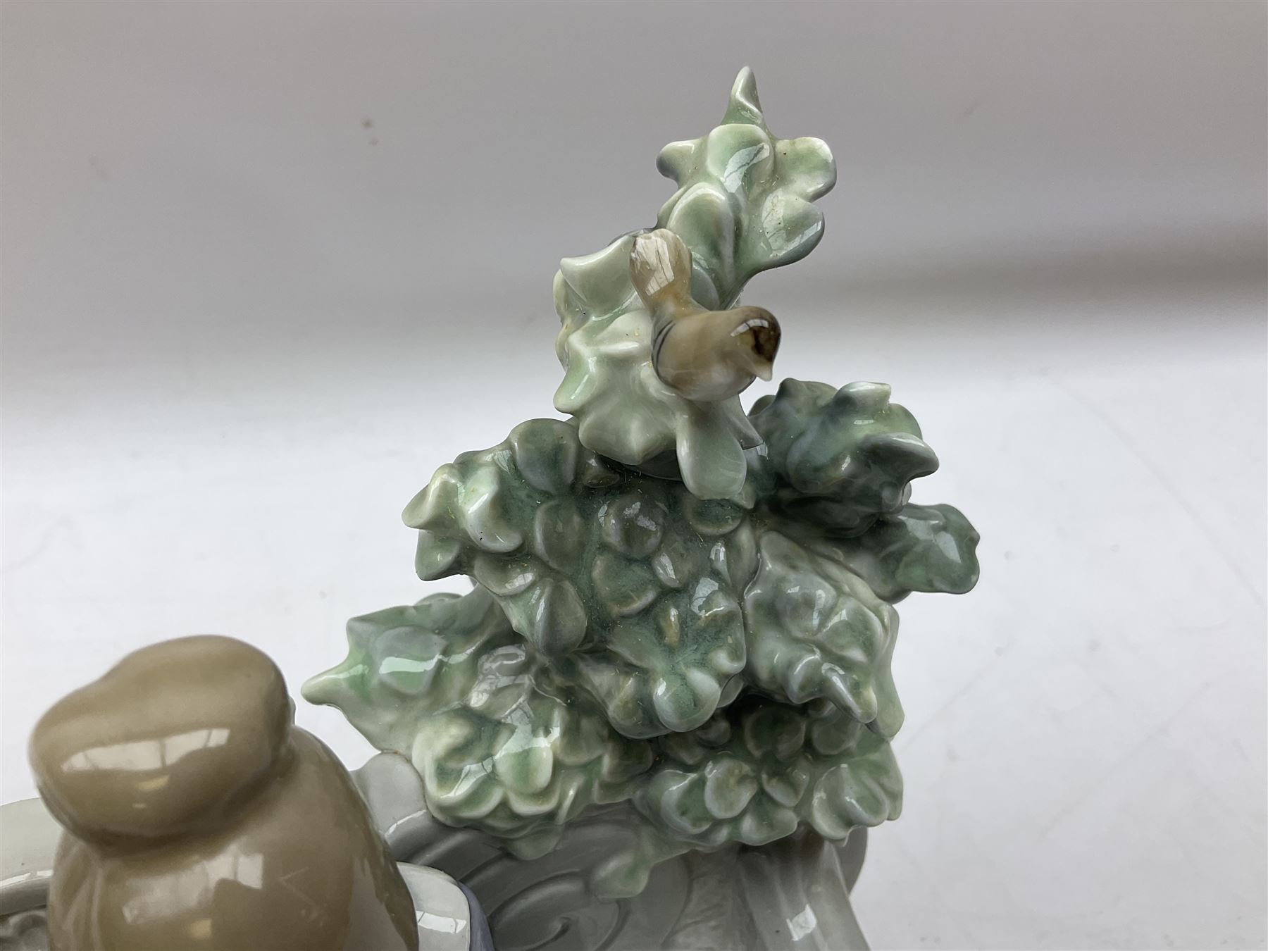 Lladro figure, Poetry of Love, modelled as a boy seated reading from a book next to a girl on garden bench with a dog at her feet, sculpted by Regino Torrijos, with original box, no 5442, year issued 1987, year retired 1998, H22cm