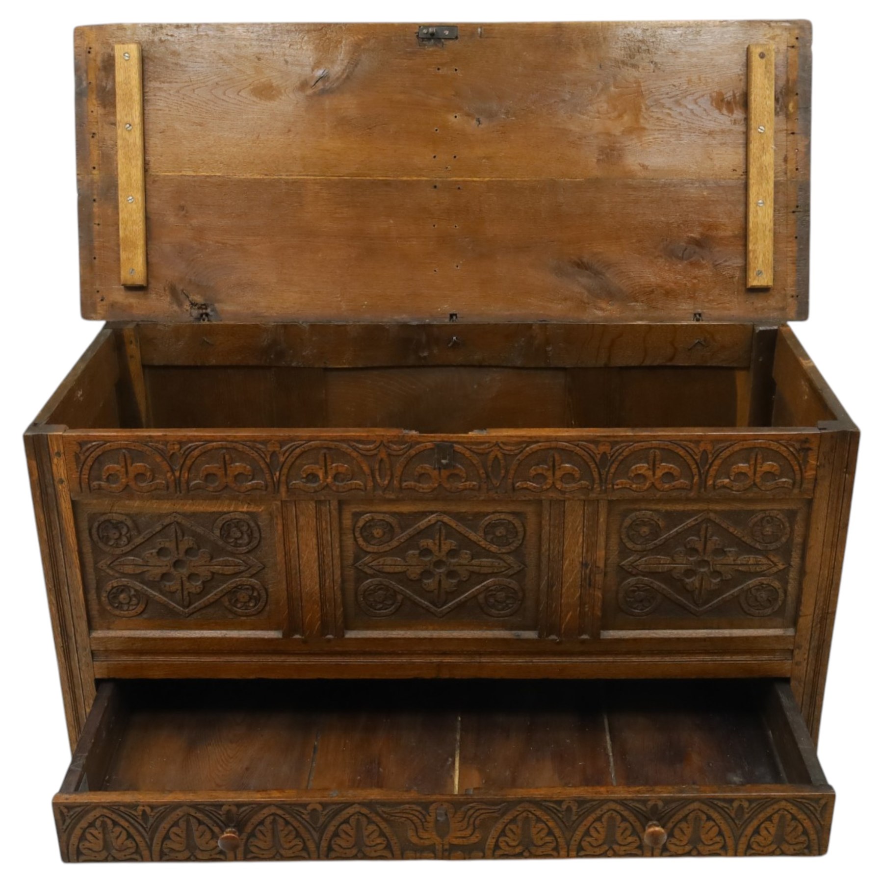 18th century carved oak coffer, rectangular hinged top over a lunette-carved frieze and tracery-style carved triple panelled front, the lower rail carved with repeating anthemion motifs, on square feet
